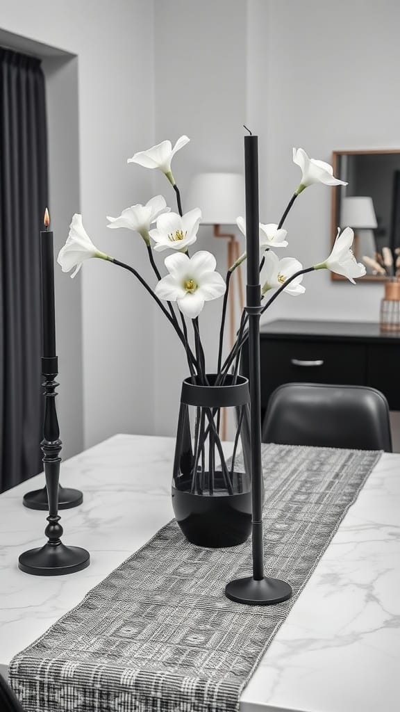 A black and white dining room table centerpiece featuring white flowers in a black vase and black candlesticks.